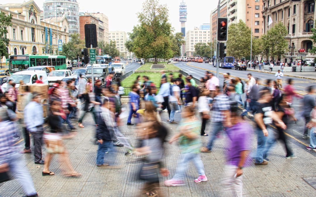 Blurred timelapse image of people milling around a street