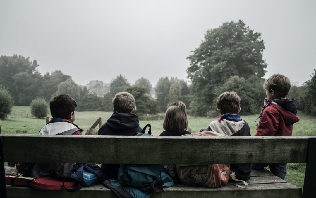 children sitting on a bench