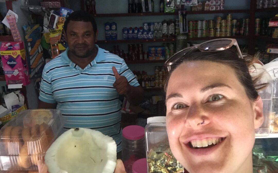 Jorje the shop-cum-hut-keeper, my first coconut and me a little excited