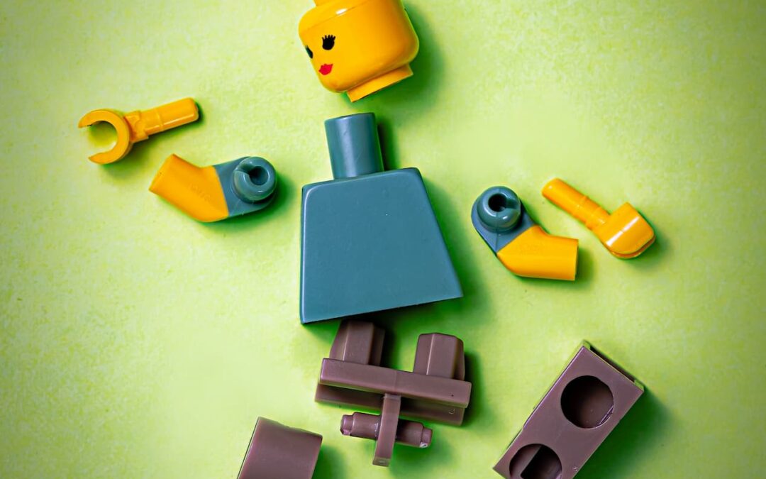 A lego person broken into pieces